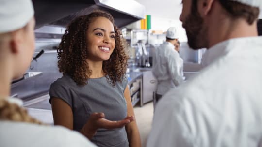 woman manager talking to servers