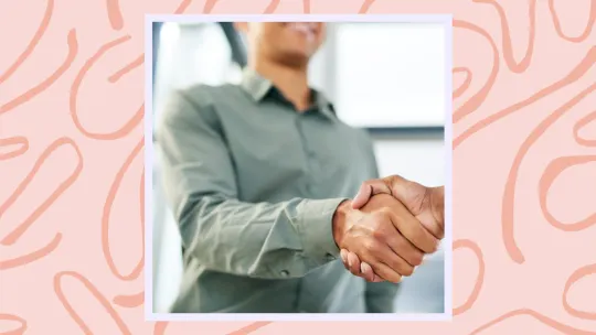 a woman shaking a person's hand