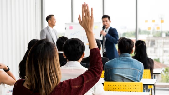 woman asking questions in a meeting