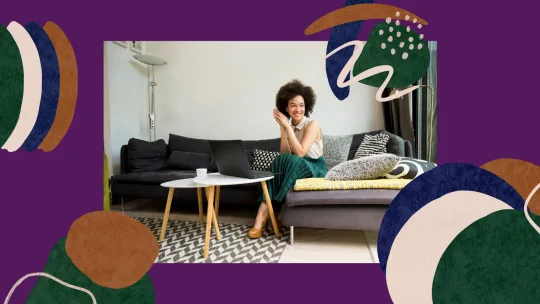woman sitting on couch with laptop in front of her