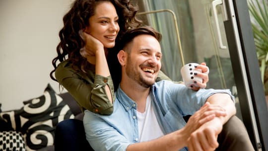Couple moving in together carrying boxes