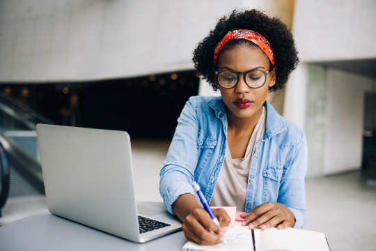 Woman Writing in Planner