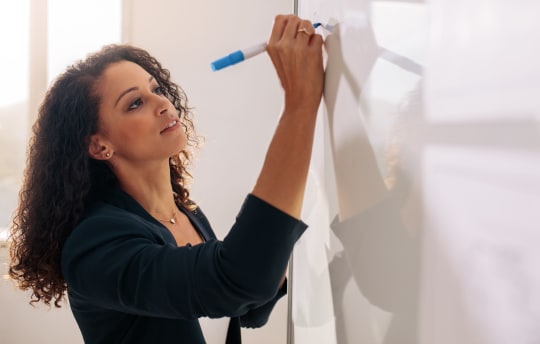 woman writing on whiteboard