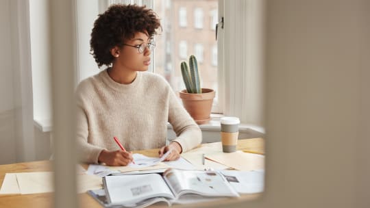 Woman writing in notebook