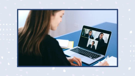 woman on laptop in a Zoom meeting with a panel