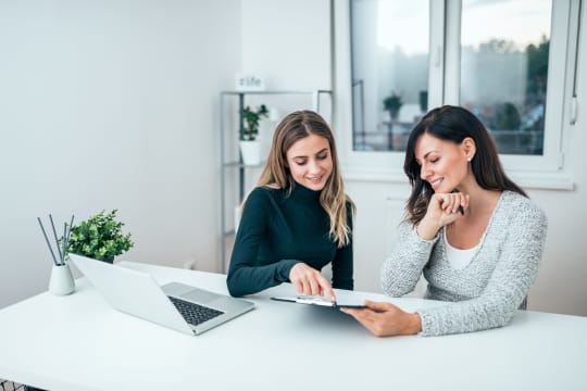 Two women speaking at work