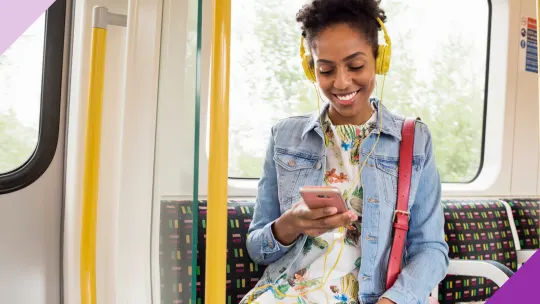 woman listening to headphones on a public bus