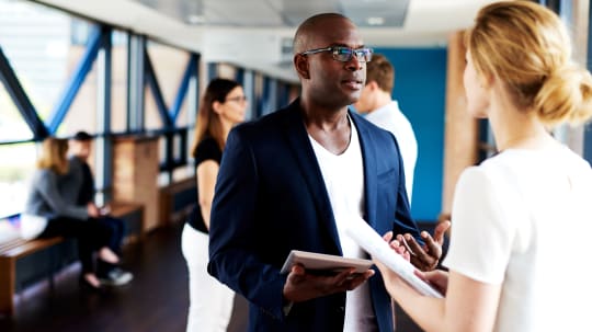 A man and a woman face each other while having a conversation