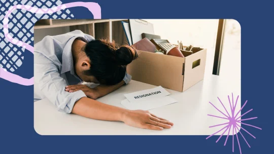 a woman with her head on her desk