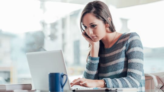 woman on her laptop with coffee