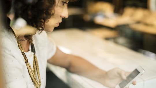 Woman staring sadly at phone