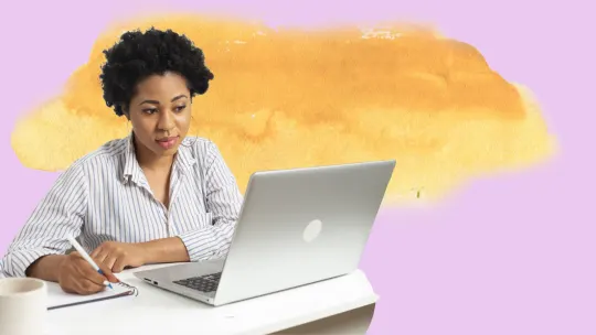 woman taking notes from computer