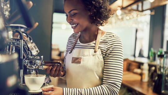 barista making a latte