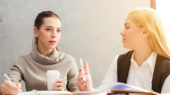 two women at work talking