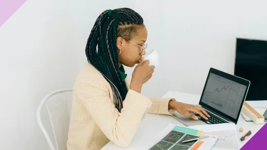 A woman at a computer investing