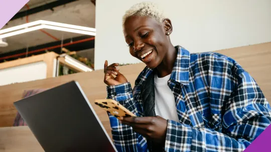 Candidate looking thrilled after receiving good news, illustrating how to accept a job offer the right way