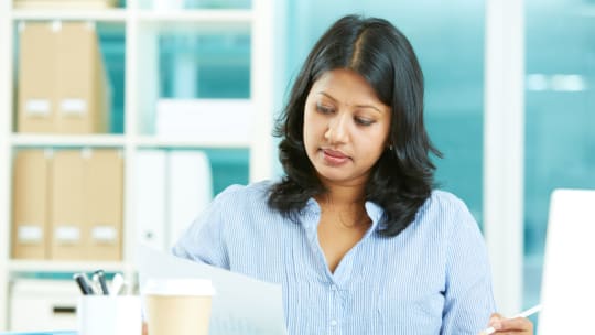 entrepreneur filing paperwork for registering a business name