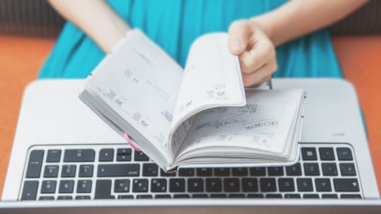 woman flipping through agenda