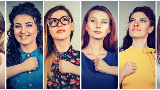 women with fist over their hearts