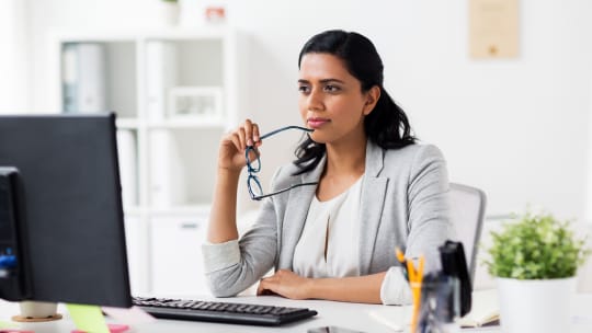 woman thinking at her computer