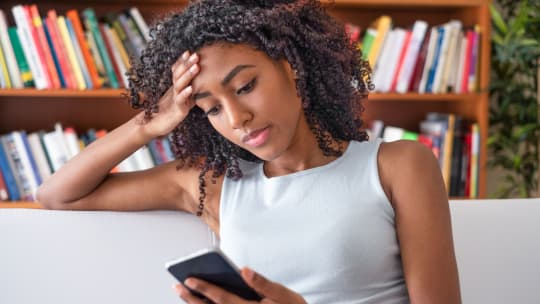 woman waiting and scrolling on phone