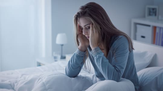 Stressed Woman in Bed