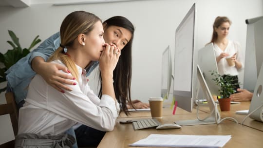 woman comforting colleague at work