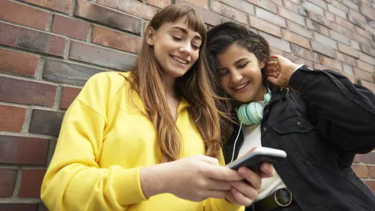two friends checking phone