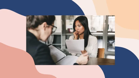 Women biting nails while interviewer looks at her resume