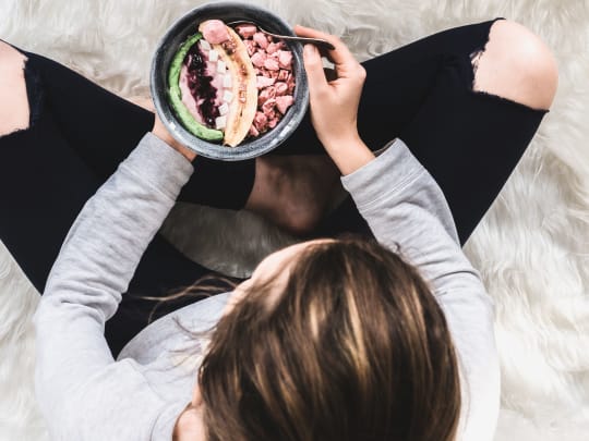 Woman eating smoothie bowl