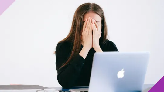An exasperated woman sitting in front of a laptop to illustrate interview fatigue