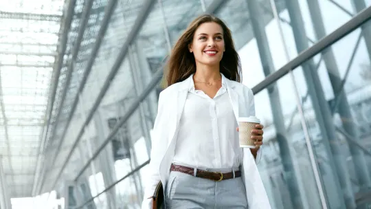 woman walking with coffee