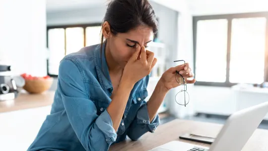 Stressed woman on laptop