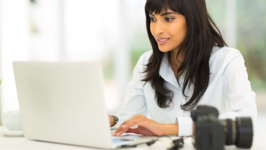 Female Journalist on Computer