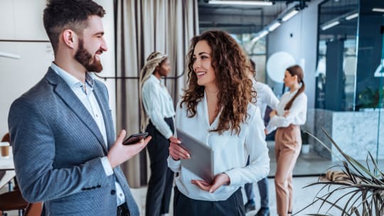 Man and woman talking at work