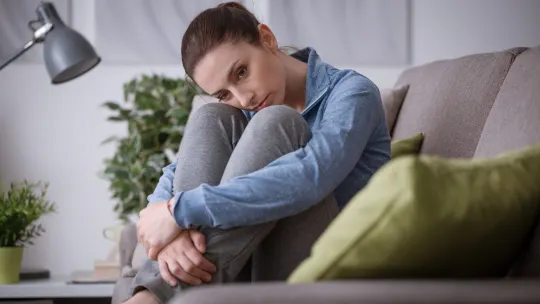 Sad woman on couch