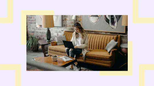 woman sitting on couch staring at laptop