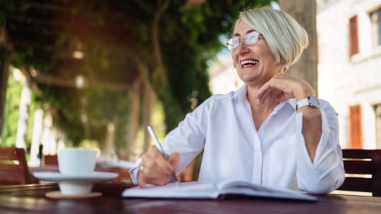 Woman writing in notebook 