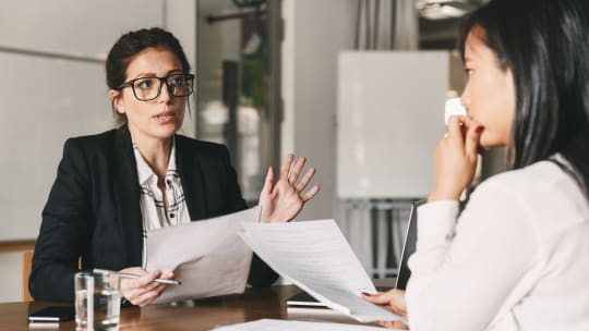 Women meet for a performance review conversation