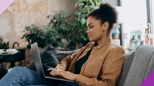A woman typing on her notebook, illustrating how to decline a job interview the right way