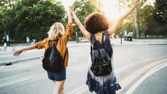 Two happy women walking