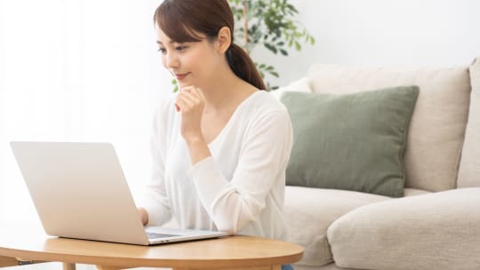 person typing on laptop and thinking