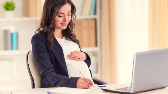 pregnant woman wearing a blazer at work