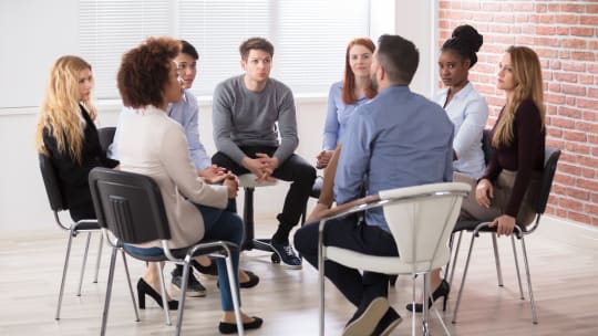 People gathered around a table talking