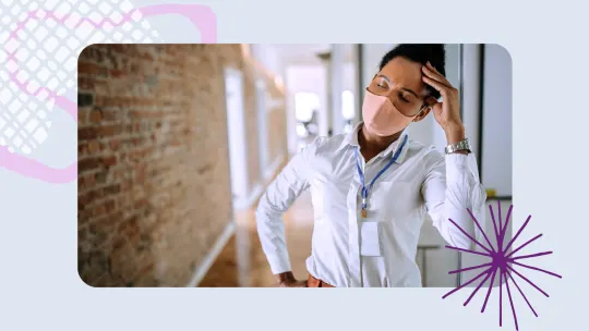 a woman wearing a pink mask stressed at work