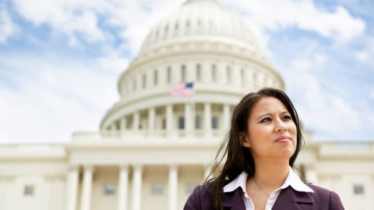 senator standing before government building
