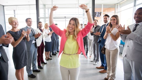 woman walking through job crowd cheering