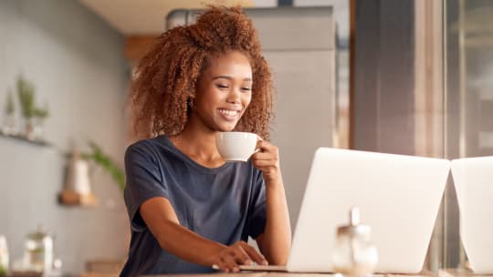 Woman smiling at computer
