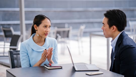 Woman talking to coworker