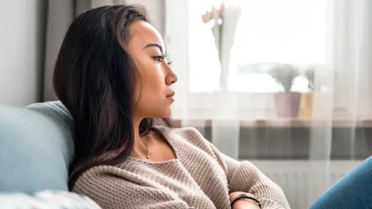 A woman looking stressed at her desk